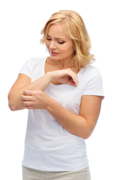 Unhappy woman suffering from hand inch — Stock Photo, Image