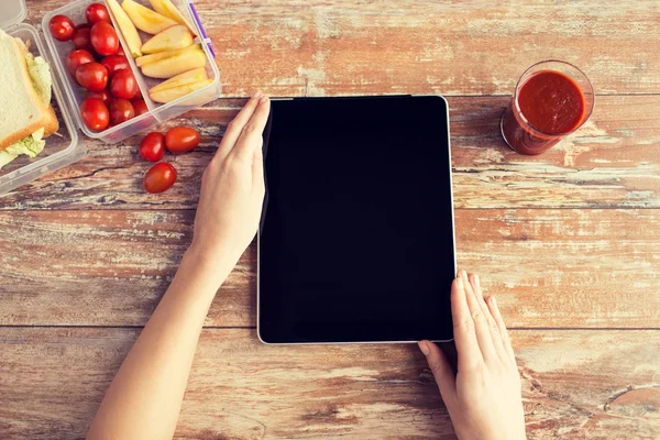 Close up of woman with tablet pc food on table — Stock Photo, Image