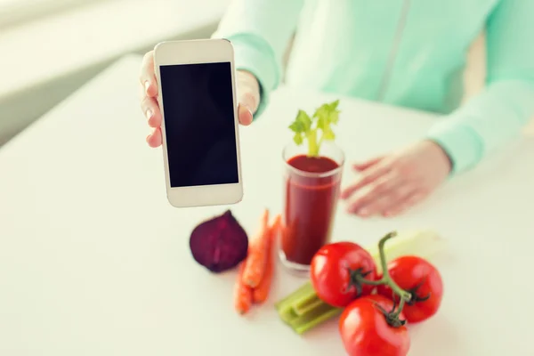 Gros plan de la femme avec smartphone et légumes — Photo