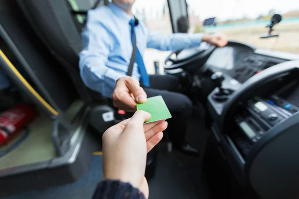 Bus driver taking ticket or card from passenger — Stock Photo, Image