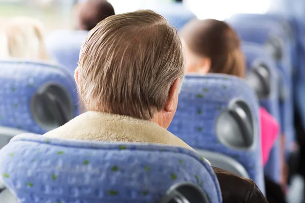 Close up of senior man sitting in travel bus — Stock Photo, Image