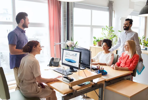Happy creative team talking in office — Stock Photo, Image