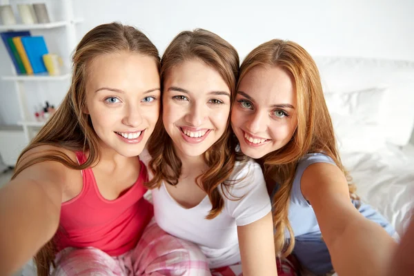 Happy friends or teen girls taking selfie at home — Stock Photo, Image
