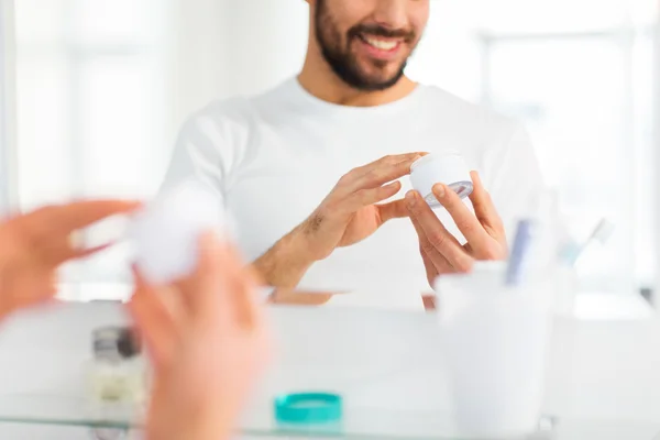 Close up of happy young man with cream at bathroom — Stock Photo, Image