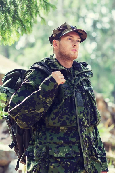 Young soldier with backpack in forest — Stock Photo, Image