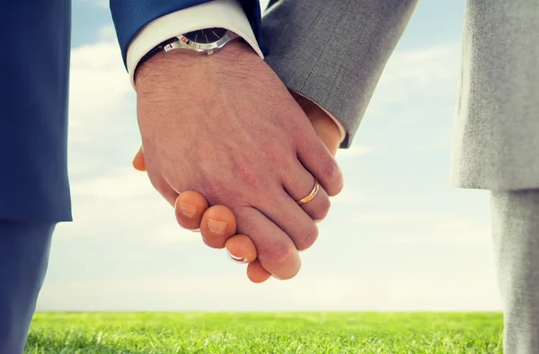 Close up of male gay hands with wedding rings on — Stock Photo, Image