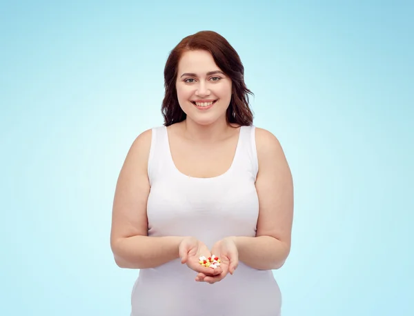 Happy plus size woman in underwear with pills — Stock Photo, Image