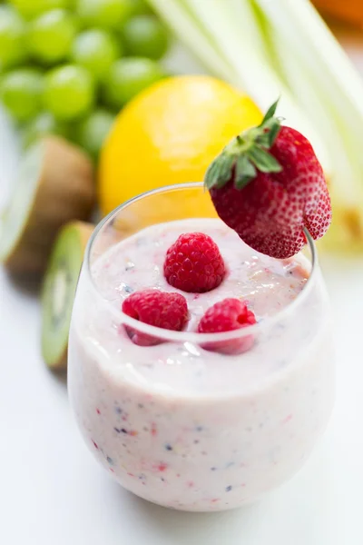 stock image close up of glass with milk shake and fruits