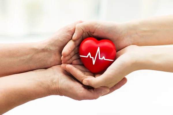 Man hand giving red heart to woman — Stock Photo, Image