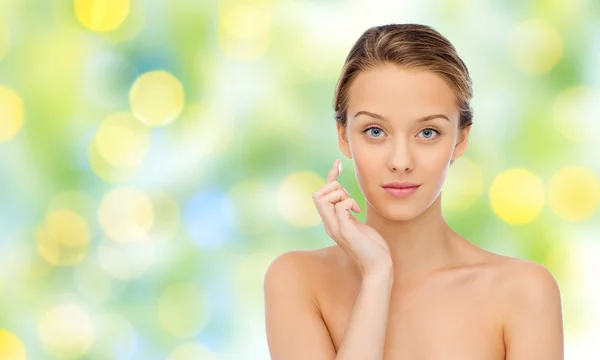 Young woman applying cream to her face — Stock Photo, Image
