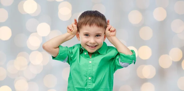 Happy little boy having fun and making horns — Stock Photo, Image