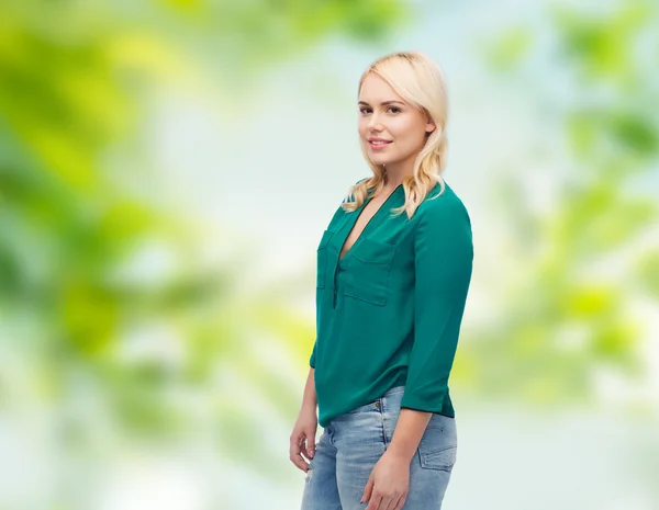 Smiling young woman in shirt and jeans — Stock Photo, Image