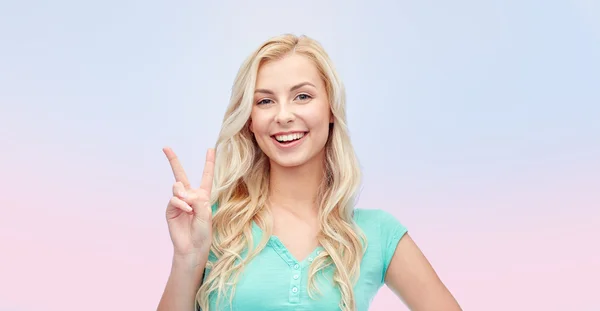 Smiling young woman or teenage girl showing peace — Stock Photo, Image