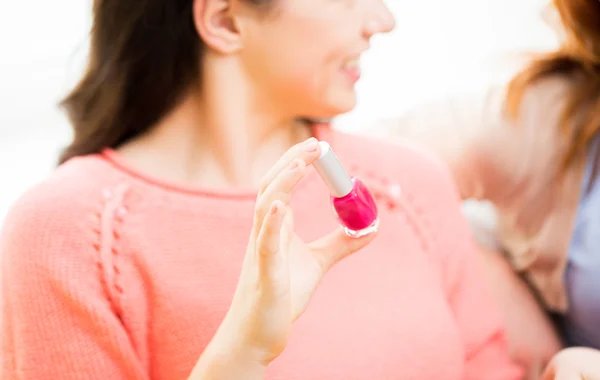 Close up of smiling young woman with nail polish — Stock Photo, Image