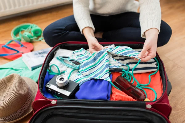 Primer plano de la mujer embalaje bolsa de viaje para vacaciones —  Fotos de Stock