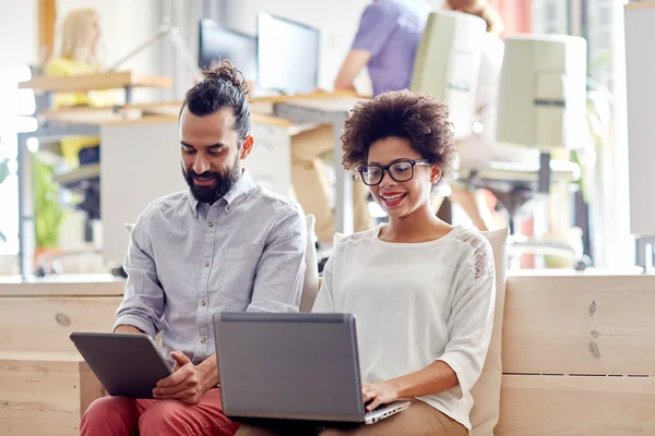 Creative team with laptop and tablet pc in office — Stock Photo, Image