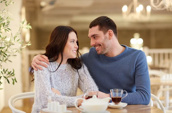 Happy couple drinking tea at restaurant — Stock Photo, Image