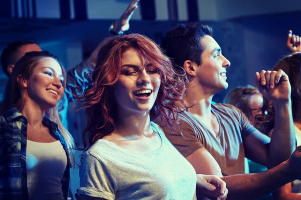 Happy friends dancing at night club — Stock Photo, Image