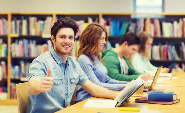 Happy student boy preparing to exam in library — Stock Photo, Image