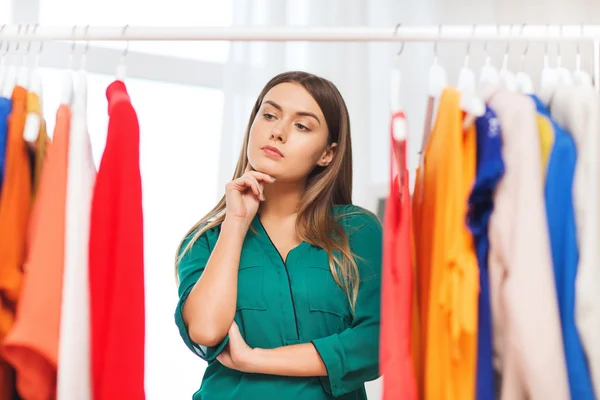 woman choosing clothes at home wardrobe
