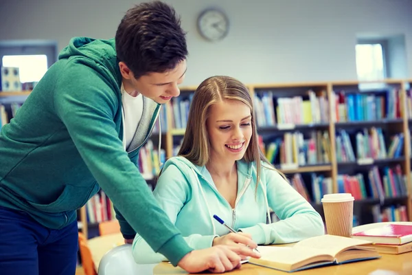 Happy students preparing to exams in library Stock Image