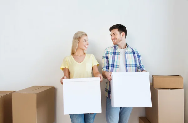 Sonriente pareja con grandes cajas moviéndose a nuevo hogar —  Fotos de Stock