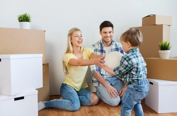 Happy family moving to new home and playing ball — Stock Photo, Image
