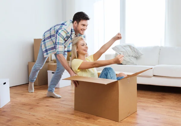 Casal feliz se divertindo com caixas em nova casa — Fotografia de Stock