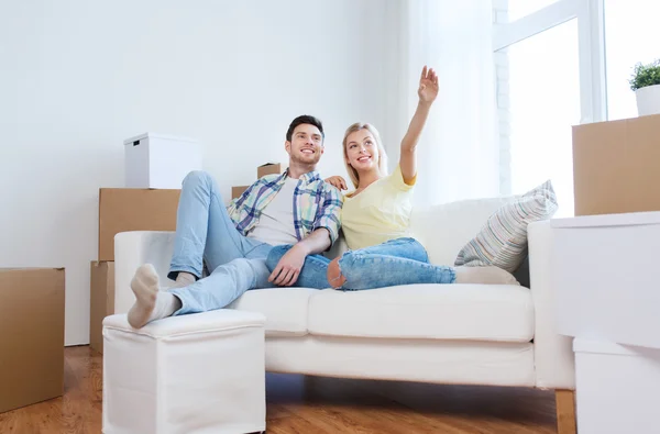 Pareja con cajas mudándose a casa nueva y soñando — Foto de Stock