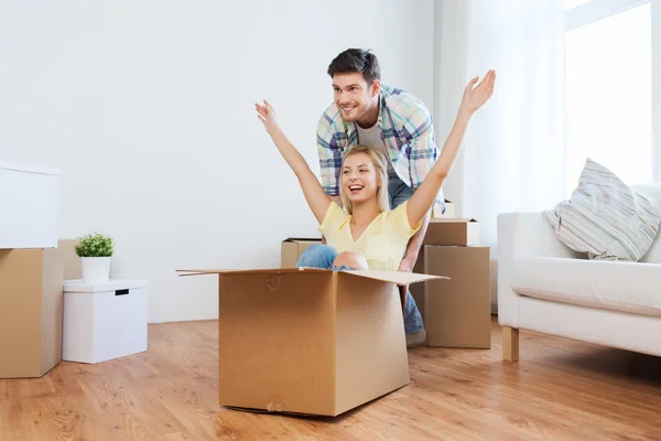 Счастливая пара, весело проводящая время с коробками в новом доме — стоковое фото