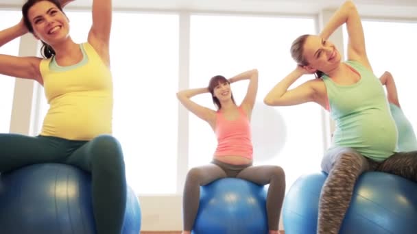 Happy pregnant women exercising on fitball in gym — Stock Video