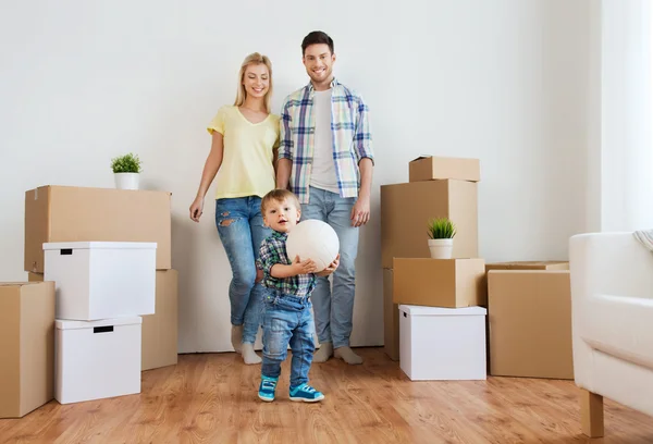 Happy family moving to new home and playing ball — Stock Photo, Image