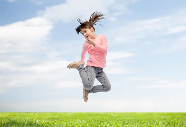 Happy little girl jumping in air — Stock Photo, Image