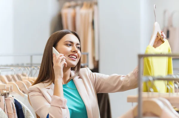 Mulher chamando no smartphone na loja de roupas — Fotografia de Stock