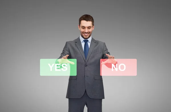 Smiling businessman with yes and no buttons — Stock Photo, Image