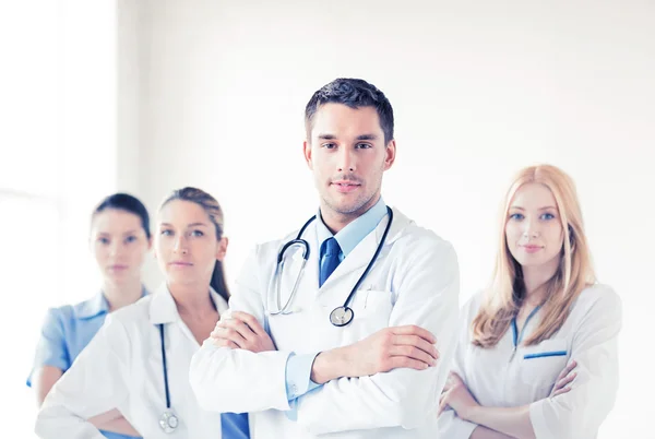 Male doctor in front of medical group — Stock Photo, Image