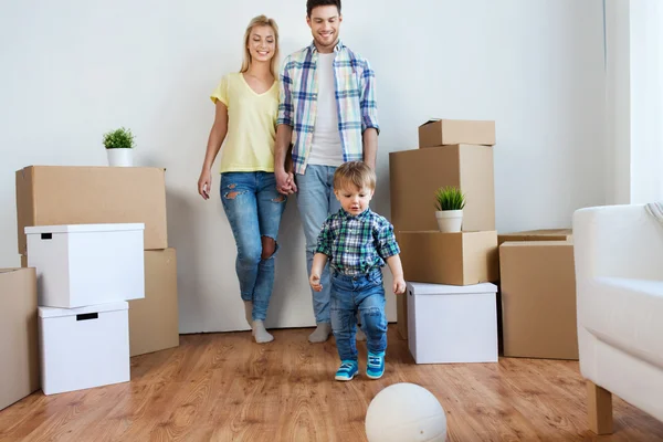 Happy family moving to new home and playing ball — Stock Photo, Image