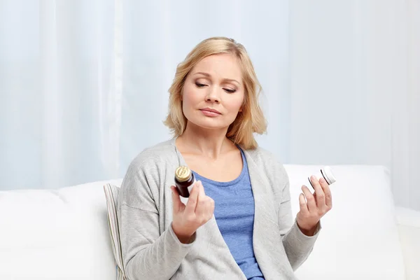 Woman with medicine jars at home — Stock Photo, Image