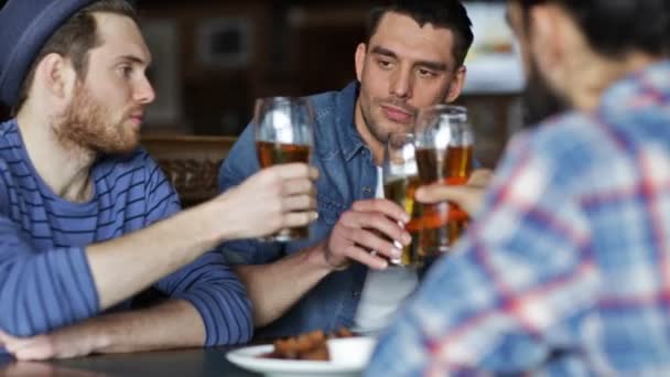 Happy male friends drinking beer at bar or pub — Stock Video