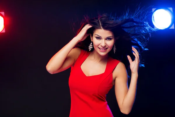 Beautiful sexy woman in red dancing at nightclub — Stock Photo, Image