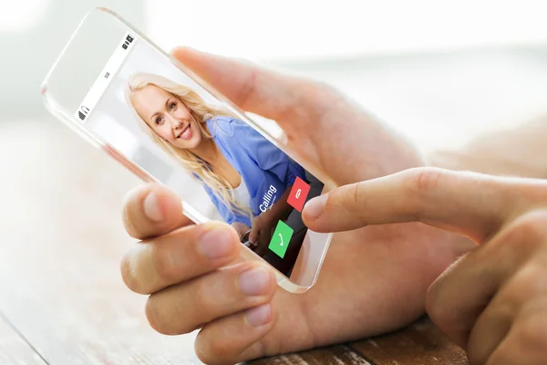 Close up of male hand with transparent smartphone — Stock Photo, Image