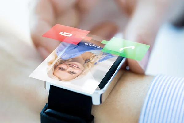 Close up of hand with incoming call on smart watch — Stock Photo, Image