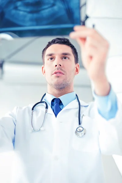 Male doctor or dentist looking at x-ray — Stock Photo, Image