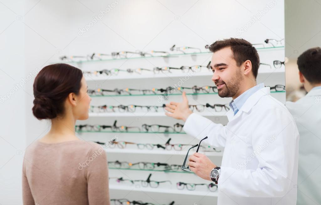 Woman and optician showing glasses at optics store — Stock Photo © Syda ...