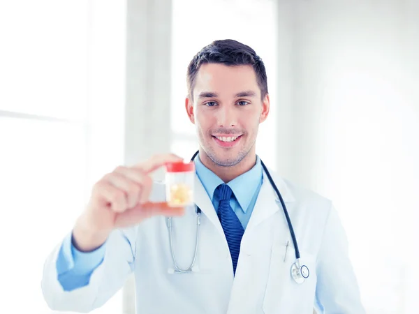 Mannelijke arts met een pot van capsules — Stockfoto