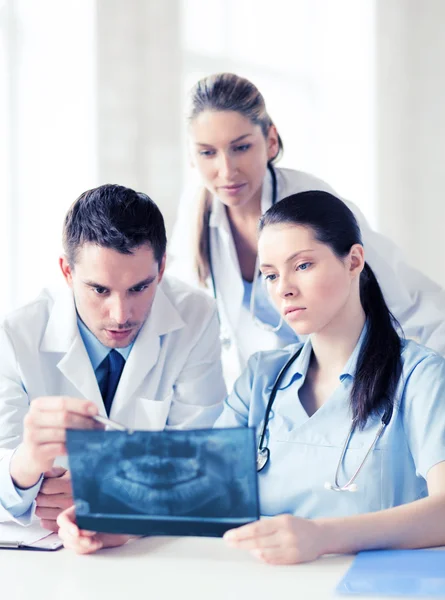 Group of doctors looking at x-ray — Stock Photo, Image