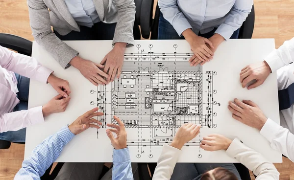 Close up of business group with blueprint — Stock Photo, Image