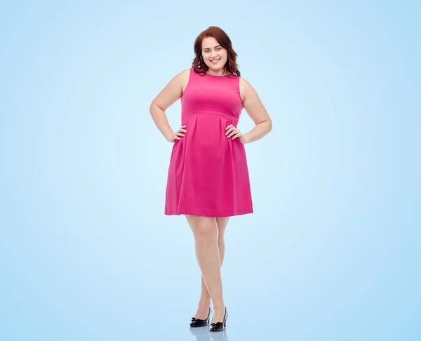 Happy young plus size woman posing in pink dress — Stock Photo, Image