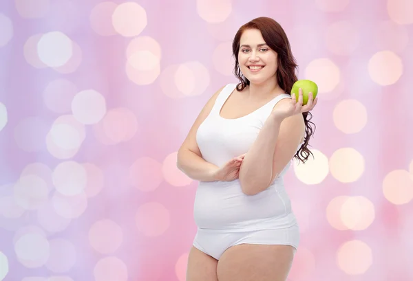 Mujer feliz más tamaño en ropa interior con manzana — Foto de Stock