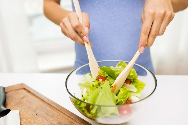 Close up of woman cooking vegetable salad at home — Stock Photo, Image